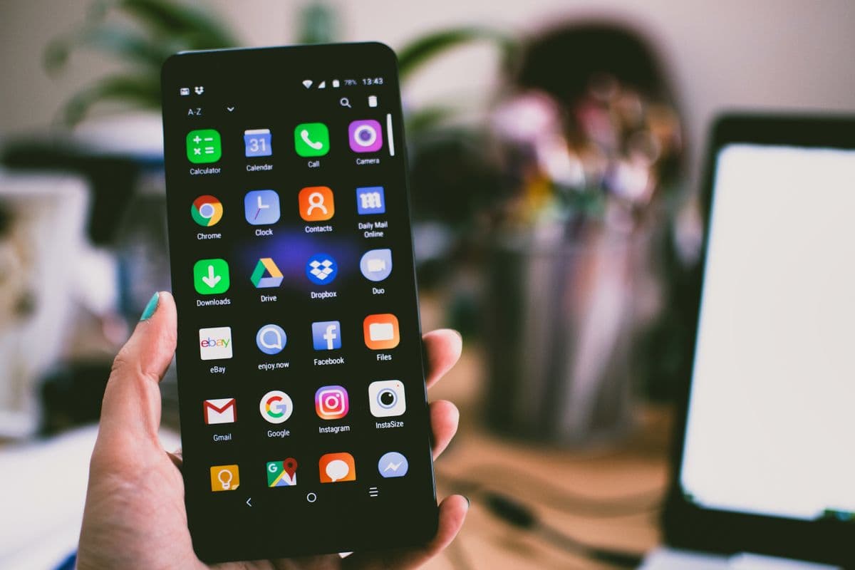 Person using a smartphone — each device has a unique FCM registration token
