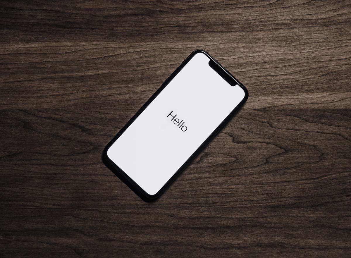 iPhone on a workspace used to test Apple Push Notification delivery via FCM