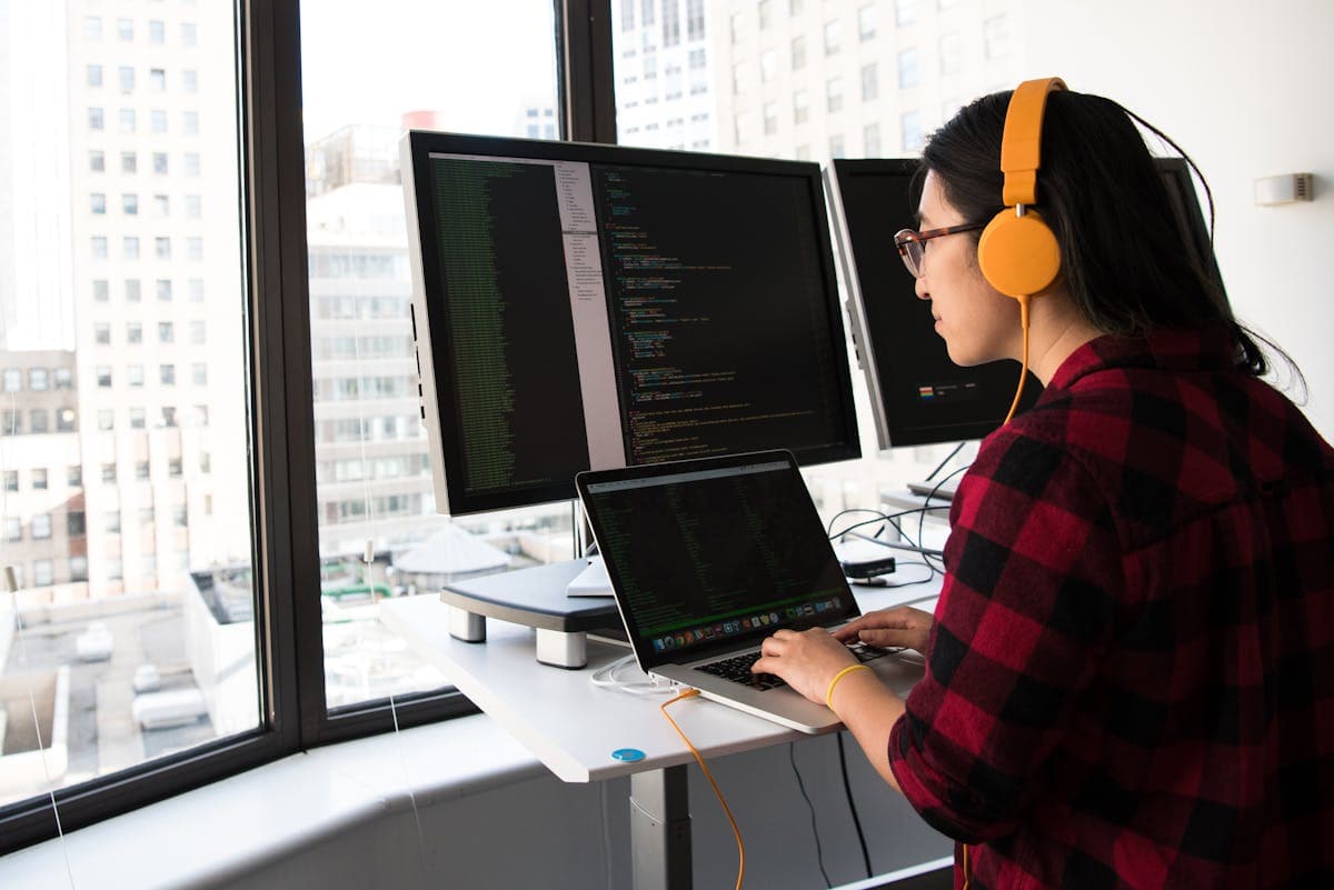 Developer writing code on a laptop to integrate FCM HTTP v1 API
